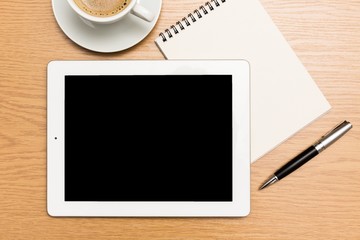 Analysis. digital tablet and cup of coffee on wooden table