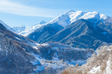 Mountain village on the snowy slope in Caucasus