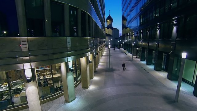 Few citizens walk by narrow street with Temple of St. Nicholas