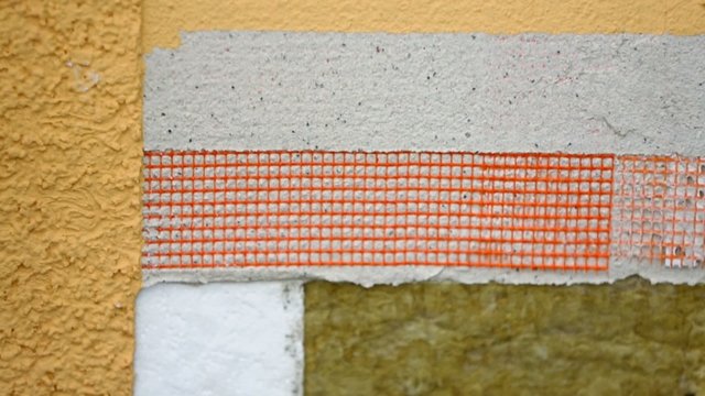 Wall covered by different materials for decoration and sound