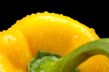 Macro cut shot of yellow bell pepper background with water drops