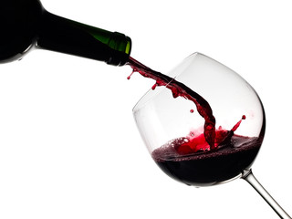 Red wine pouring with drops