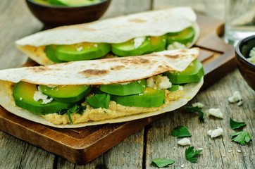tortilla with hummus, avocado, feta and parsley