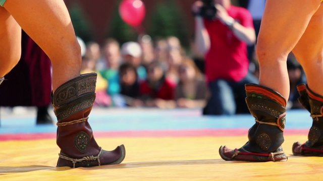 Leg of fighters during duel of Mongolian wrestling