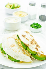 tortilla with hummus, avocado, feta and parsley