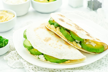 tortilla with hummus, avocado, feta and parsley