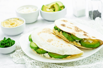 tortilla with hummus, avocado, feta and parsley