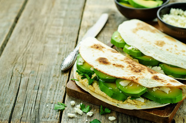 tortilla with hummus, avocado, feta and parsley