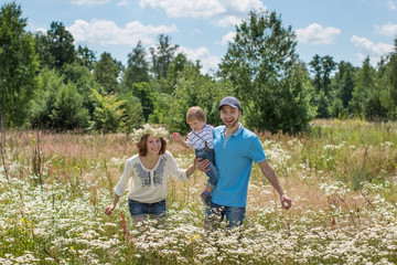 Obraz premium Young Attractive Parents and Child Portrait Outdoors