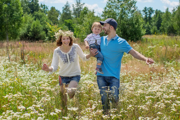 Fototapeta premium Young Attractive Parents and Child Portrait Outdoors