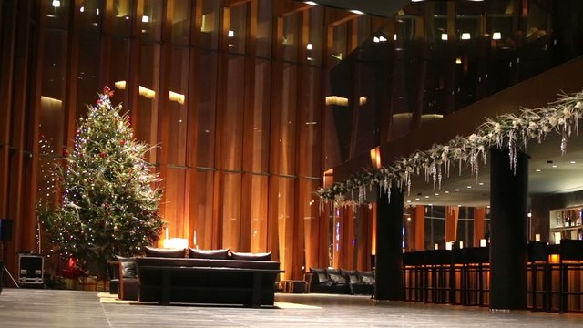 hall with decorated Christmas firtree during New Year holidays.
