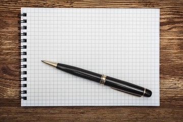 Background. close up opening note paper and pen on wood texture