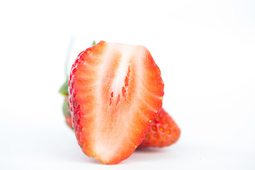 Closed up half of strawberry on white