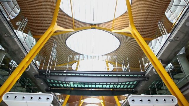 Passengers walk in hall of Madrid Barajas Airport 
