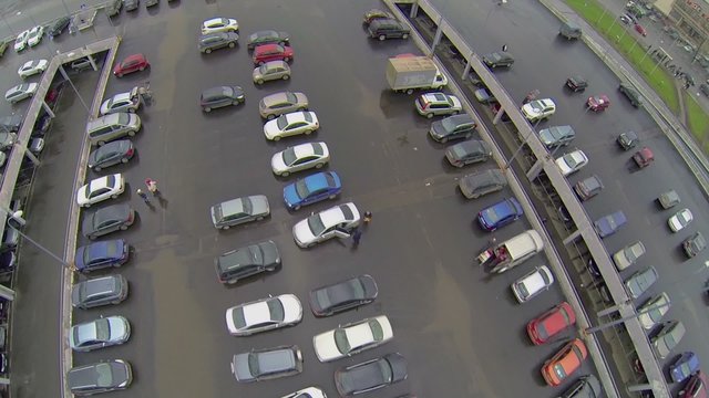 Cars ride by large parking near shopping center Mall Gallery