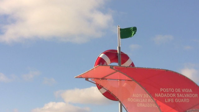 Safe guarded beach life guard green flag