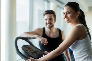 Beautiful, young people talking in a gym while working out