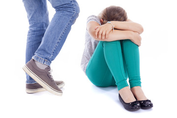 Naklejka premium Little girl being kicked by a boy, isolated on white background