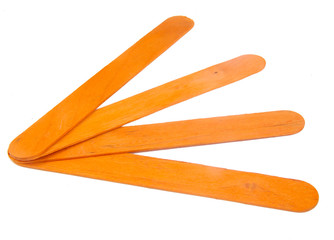 Four popsicle orange sticks for arts and crafts on a white