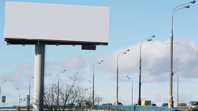 Blank billboard and route with many cars at summer day in city