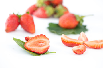 Closed up half of strawberry on green leaf