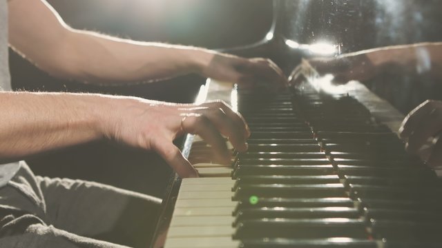 Finger on the piano, vintage colors.