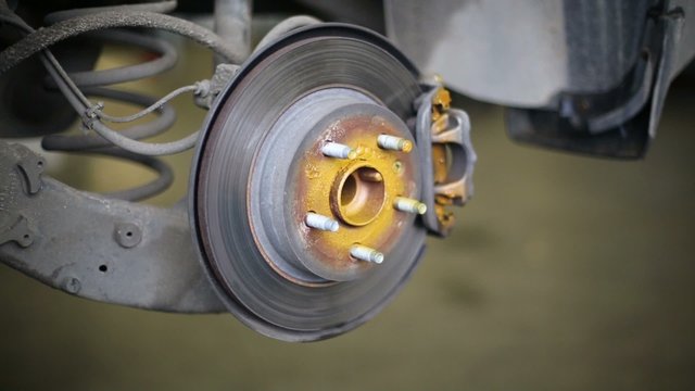 Brake disc anticorrosion spray processing at car workshop