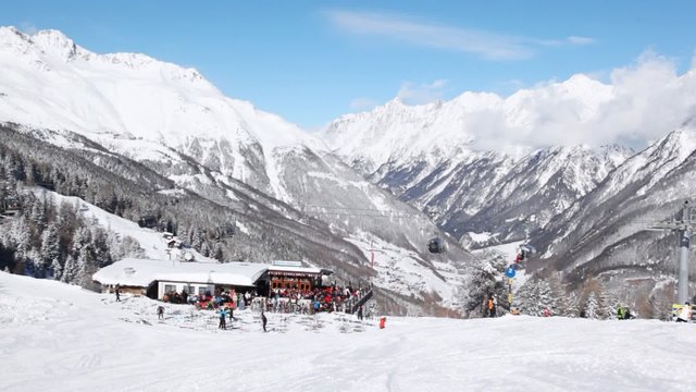 Skiers stands near point of hire of equipment