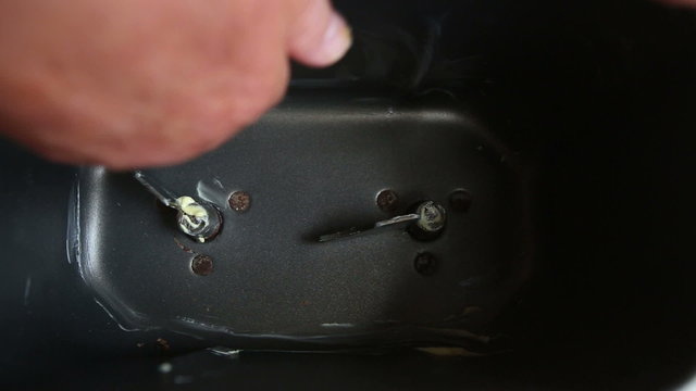 closeup of caucasian woman hands sets knives in container
