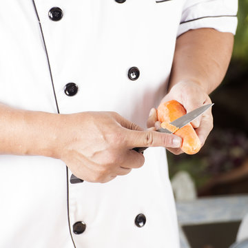 Chef is peeling carrots