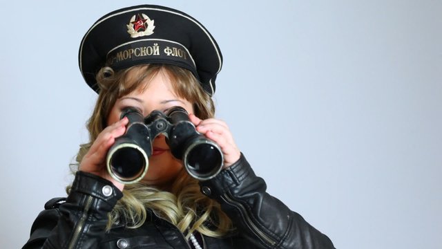 Pretty woman with Black sea Fleet army hat and binocle posing