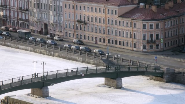 People crossing the river over the bridge, zoom in, timelapse