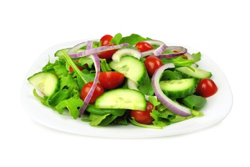 Salad with greens, tomatoes, red onions and cucumber isolated