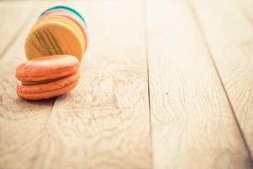 Colorful macaron on wooden floor in Vintage style