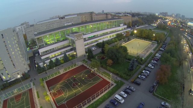 Students play soccer on playground of sports complex