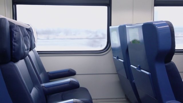 Few empty chairs at window at passengers train wagon