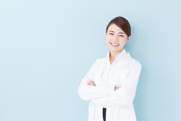 young asian doctor on blue background