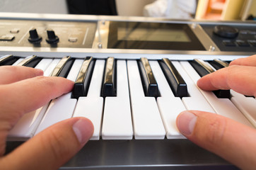 closeup photo of a person's hands playing piano