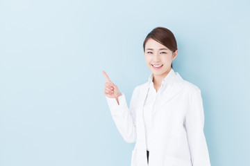 young asian doctor on blue background