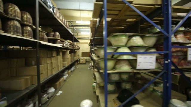 Large warehouse with long shelves full of flowerpot 