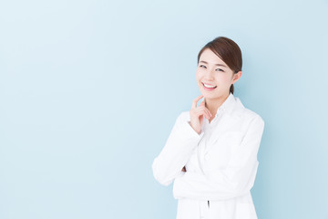 young asian doctor on blue background