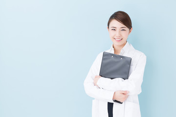 young asian doctor on blue background