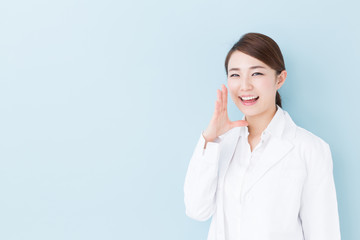 young asian doctor on blue background