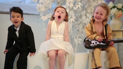 Beautiful children in costumes stars which sit on letters love