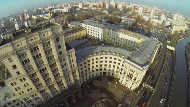 Cityscape with traffic on quay of Yauza river near university