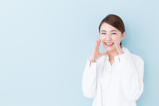 young asian doctor on blue background