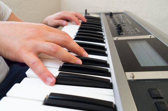 closeup photo of a person's hands playing piano