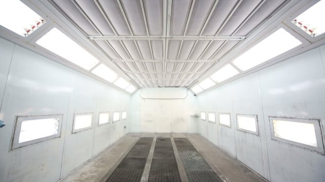 Simple paint-spraying booth with metal walls for cars
