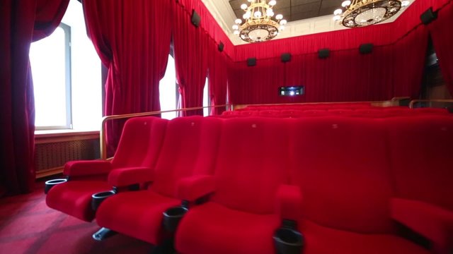 Big hall with red curtains in cinema at GUM