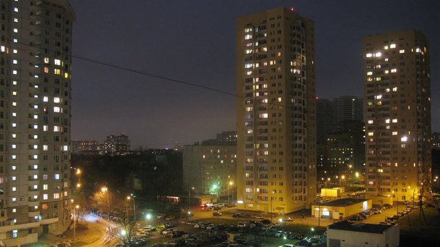 Night panorama of city street and parking lot. Timelapse